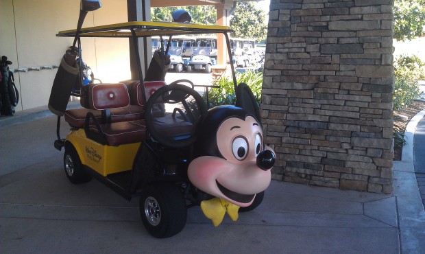 The Mickey Mouse golf cart parked near the clubhouse entrance.
