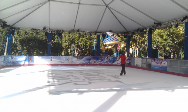 A couple cast members skating on the new ice rink in Downtown Disney