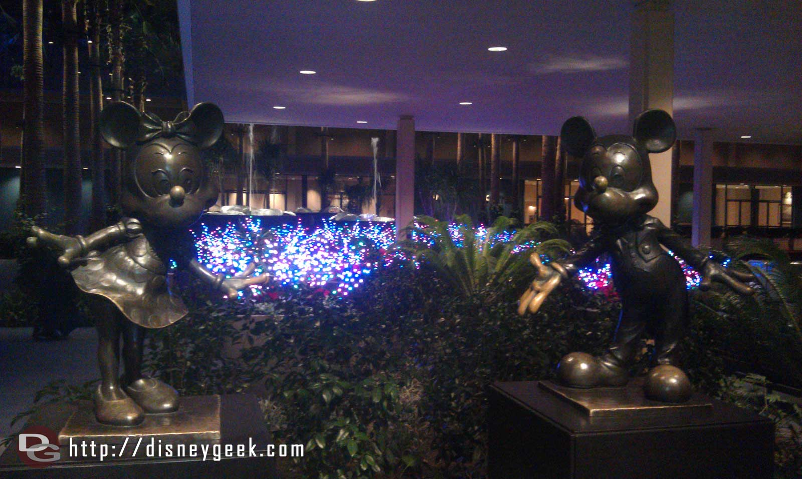 The flowerbeds around the fountains in front of the Fantasy Tower are full of lights.