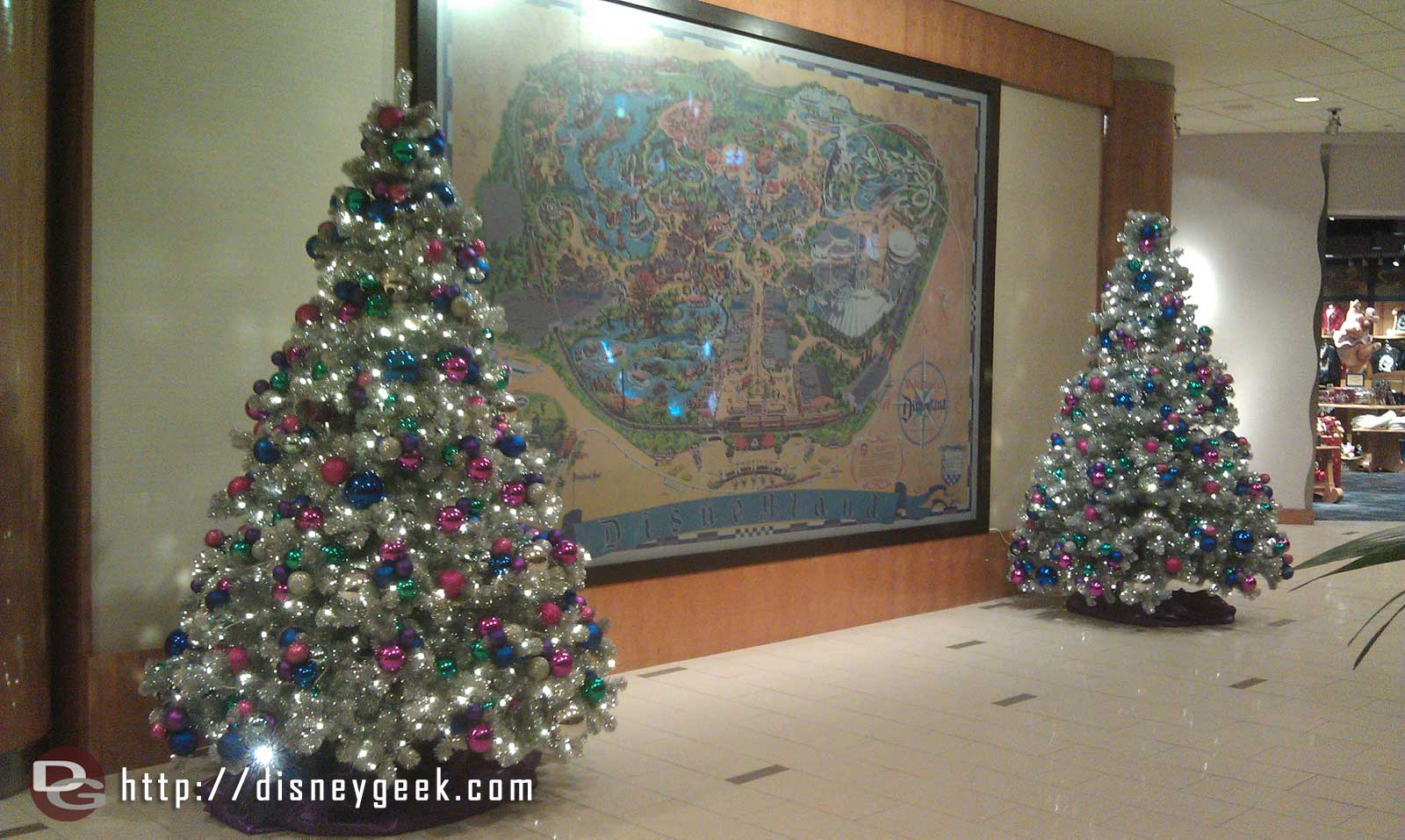 Two trees flank the Disneyland map in the Fantasy Tower lobby.