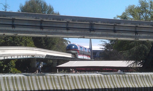Monorail Orange was stopped near Small World mall, now going backwards with guests onboard, guessing back to DD