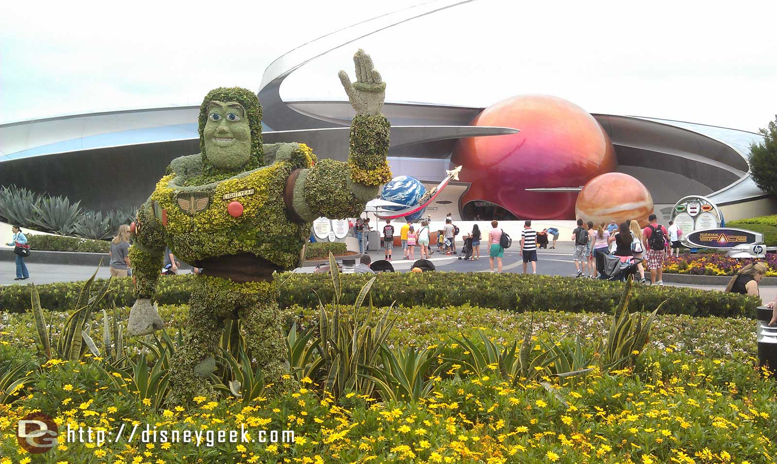 Buzz topiary out front of Mission Space