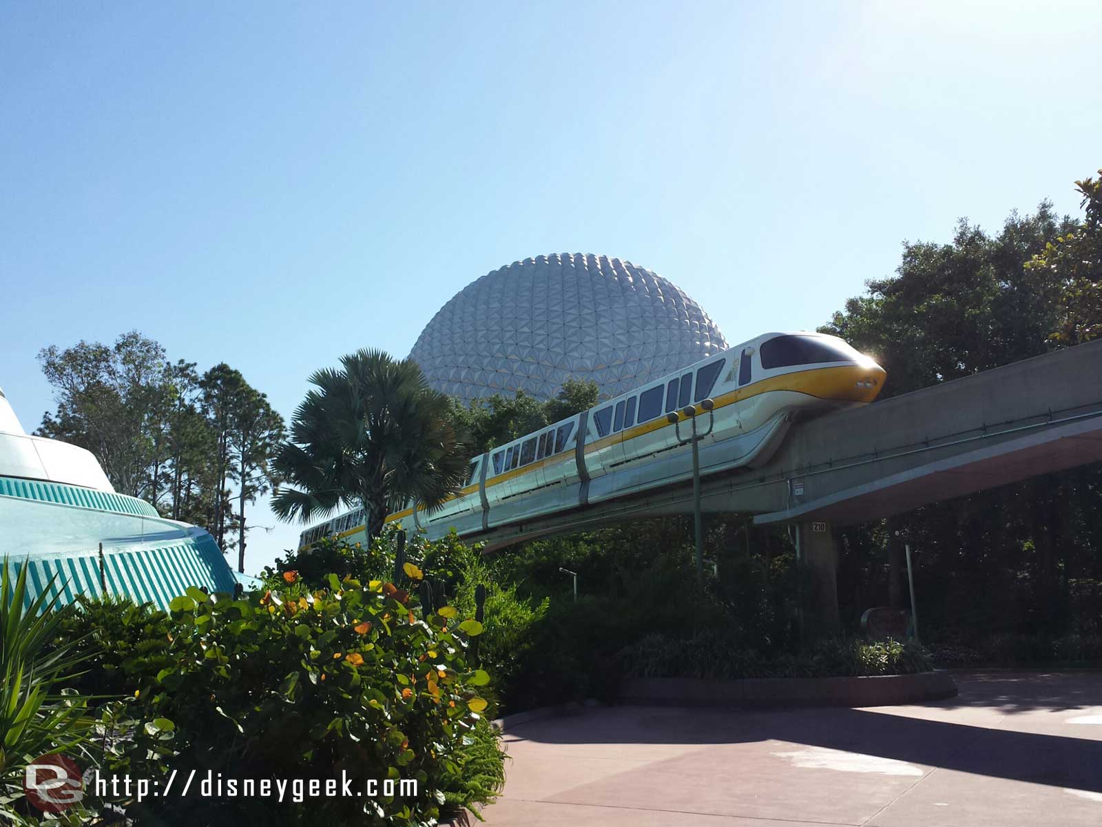 Monorail Yellow passing overhead with Spaceship Earth in the Background