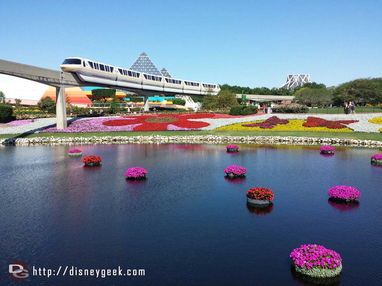 Monorail passing over the floating baskets and large flower beds of Future World - Epcot International Flower & Garden Festival