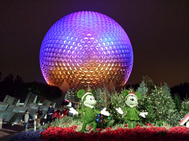 Spaceship Earth with Mickey and Minnie topiaries in front welcoming you to Epcot