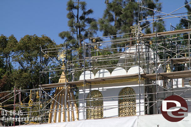 Some of the tarp is removed from the Small World scaffolding revealing the restored facade.