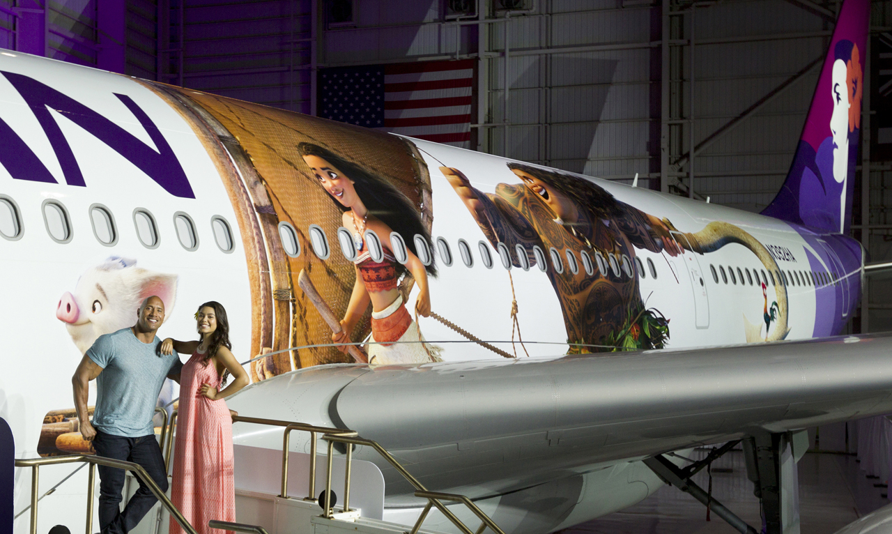 Hawaiian Airlines today revealed the first of three “Moana”-themed planes at its home base at Honolulu International Airport (HNL). Auli‘i Cravalho, the Hawai?i-born actress who is the voice of Disney’s “Moana,” and Dwayne Johnson, the voice of demigod Maui, were among the first to see the inspiring new design. Photo by Donald Traill for Hawaiian Airlines