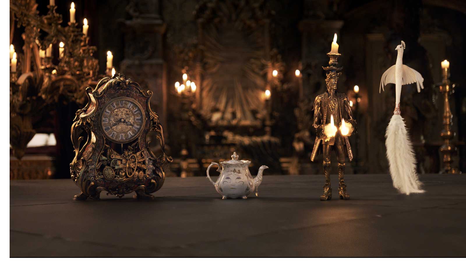 The mantel clock Cogsworth, the teapot Mrs. Potts, Lumiere the candelabra and the feather duster Plumette live in an enchanted castle in Disney's BEAUTY AND THE BEAST the live-action adaptation of the studio's animated classic directed by Bill Condon.