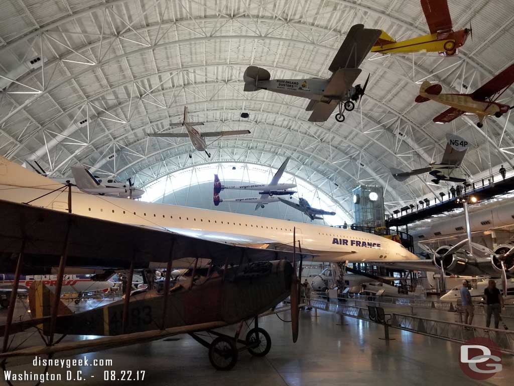 The hangar had planes suspended at different heights plus on the ground.