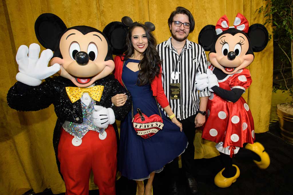 Guests pose with Mickey Mouse and Minnie Mouse at D23’s 10-Year FAN-niversary Celebration at the Walt Disney Studios, March 10, 2019.