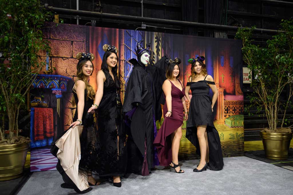 Guests pose with Sleeping Beauty’s Maleficent at D23’s 10-Year FAN-niversary Celebration at the Walt Disney Studios, March 10, 2019.
