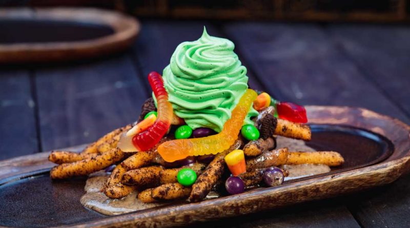 At Award Wieners at Disney California Adventure Park, guests will find these Oogie Boogie-inspired funnel cake fries dusted in crushed chocolate cream cookies, topped with cream cheese sauce, chocolate cream cookie pieces, gummy candies, chocolate coated candies and whipped cream. (David Nguyen/Disneyland Resort)