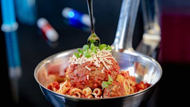 Experiment No. EE45: ImpossibleTM Spoonful, a pasta dish featuring plant-based Impossible™ large and micro meat-balls, served in a super-sized spoon with a tiny fork. (David Nguyen/Disneyland Resort)