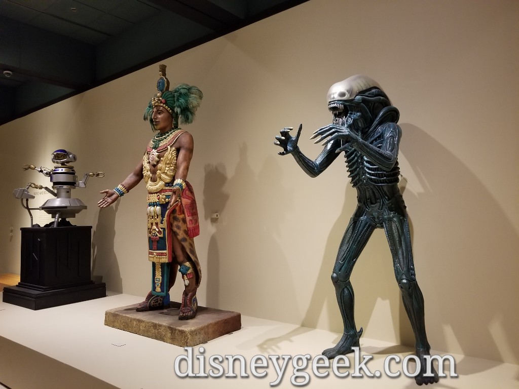 An Alien from the Great Movie Ride and a figure from El Río del Tiempo (The River of Time - boat ride in Mexico at Epcot) plus Rex.