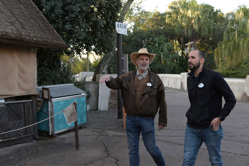 Joe Rohde (Creative Portfolio Executive Walt Disney Imagineering), Kyle Price (Art Director). Joe and Kyle walk along the park path. (Charlene Guilliams/Disney)