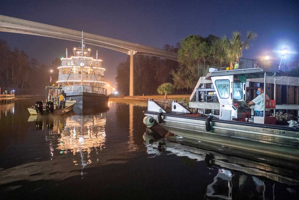 Cast members oversee repositioning the Liberty Belle riverboat following a nearly complete scheduled refurbishment of Rivers of America inside Magic Kingdom Park at Walt Disney World Resort in Lake Buena Vista, Fla. The authentic paddle wheeler was returned to the park from a temporary dry dock. (Kent Phillips, photographer)