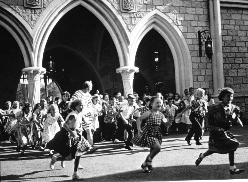 OPENING DAY, FANTASYLAND (1955) -Ð Hundreds of children run through Sleeping Beauty Castle after the long-awaited lowering of the drawbridge into Fantasyland.
