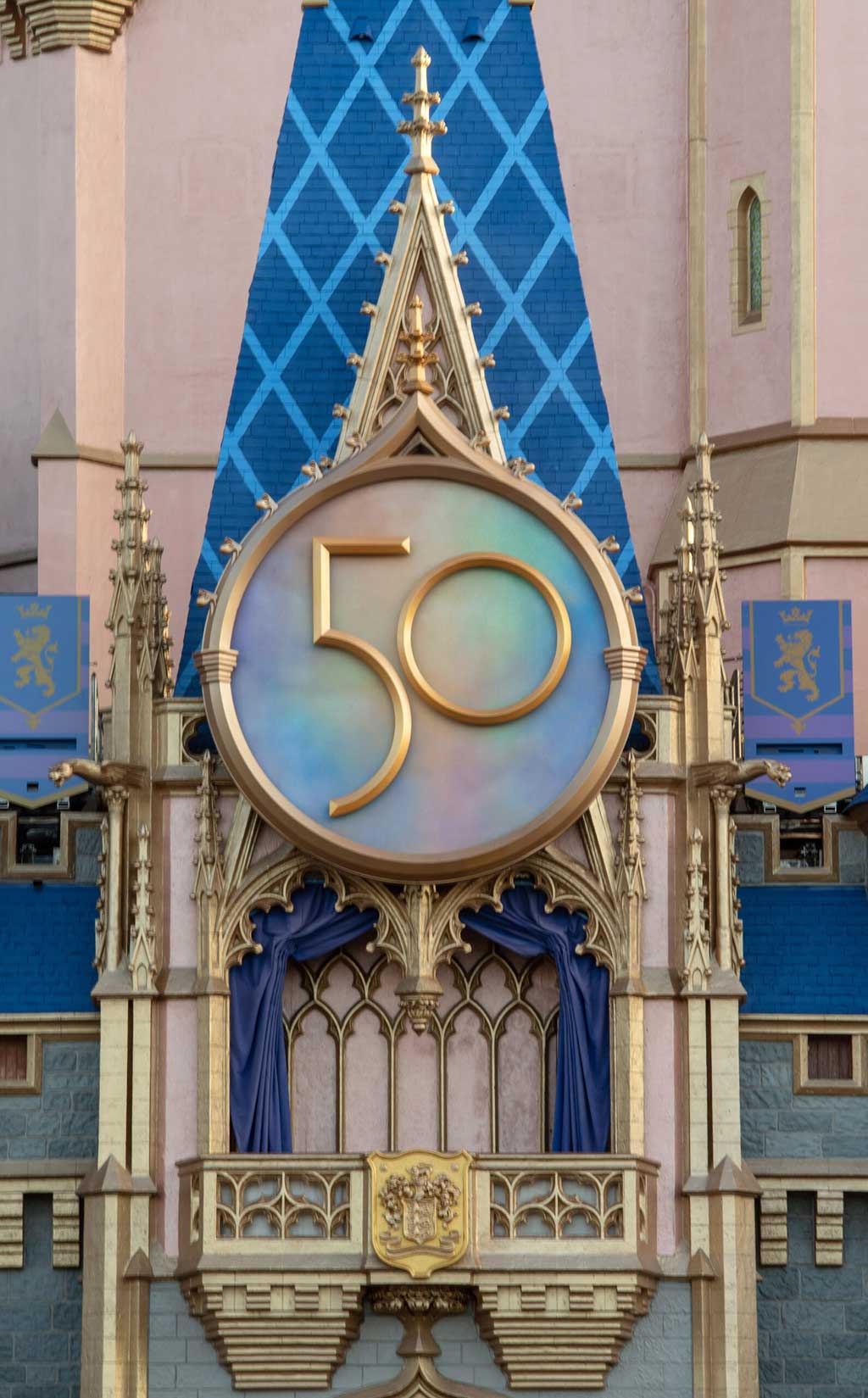 A new crest honoring the 50th anniversary of Walt Disney World Resort adorns Cinderella Castle at Magic Kingdom Park in Lake Buena Vista, Fla. The crest completes the castle’s royal, EARidescent makeover, joining gold bunting, sparkling embellishments and other new enhancements leading up to “The World’s Most Magical Celebration” beginning Oct. 1, 2021. (Kent Phillips, photographer)