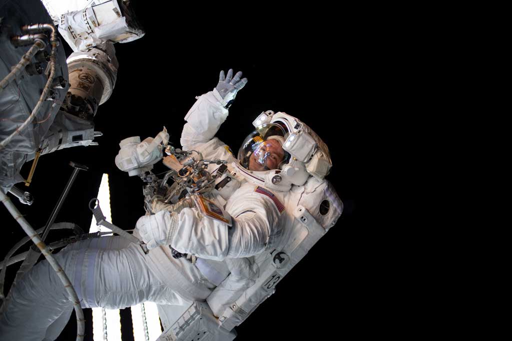 AMONG THE STARS - (Aug. 21, 2019) - NASA astronaut Andrew Morgan waves as he is photographed during a spacewalk to install the International Space Station’s second commercial crew vehicle docking port, the International Docking Adapter-3 (IDA-3).