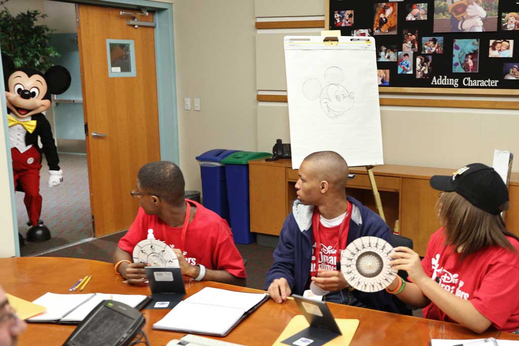 Disney Dreamers receive a surprise visit from Mickey Mouse March 8, 2014 during an animation and graphic design workshop at Disney's Hollywood Studios in Lake Buena Vista, Fla. The special experience was part of Disney Dreamers Academy with Steve Harvey and Essence Magazine, a career-inspiration program for 100 high school students from across the U.S. taking place at Walt Disney World Resort March 6-9, 2014.(Gregg Newton, photographer)