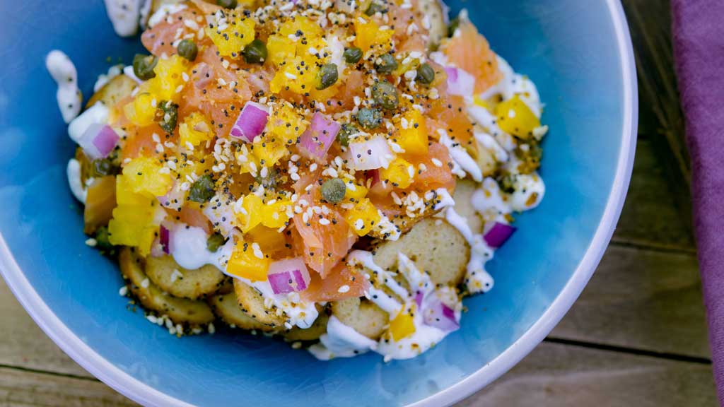 ox & Everything Bagel Nachos (A Twist on Traditions marketplace at Disney California Adventure Park in Anaheim, Calif.) - Bagel chips, cream cheese, diced smoked salmon, everything spice and, mixture of onions, tomatoes and capers.