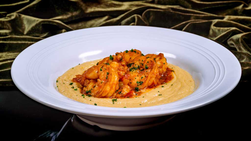 Gulf Shrimp and Grits – simmered in creole sauce with cheesy grits.