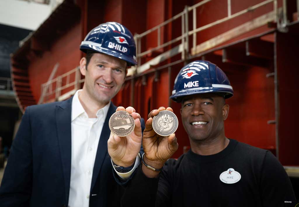 Portfolio Project Management Executive Philip Gennotte and Project Management Executive Mike Davie from Walt Disney Imagineering Germany celebrated the keel laying ceremony for the Disney Destiny in Papenburg, Germany. Keel laying takes place when a newly minted coin is placed under the first block for good fortune. (Disney) 